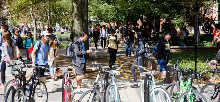 students walking by bikes on campus