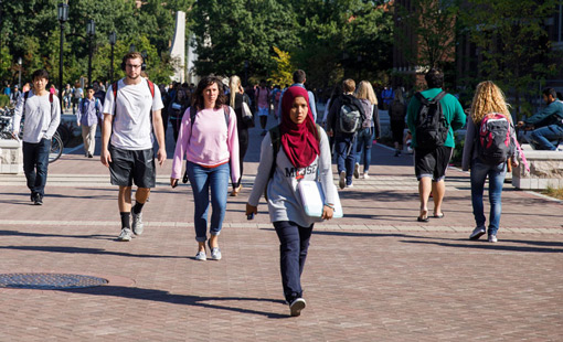 students walking on campus in the sunshine