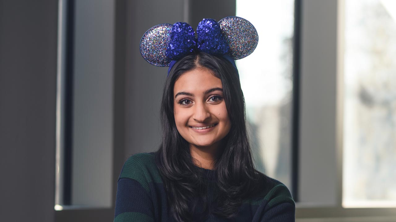Niyati Sriram wearing purple Minnie Mouse ears.
