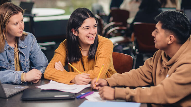 Purdue students studying at table.