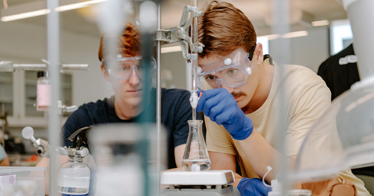 two males in lab with goggles