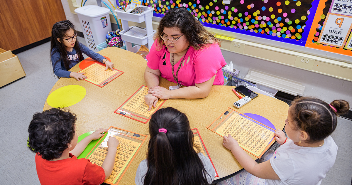 A teacher leads a group of students in a lesson