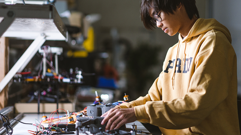 An engineering student works at a station