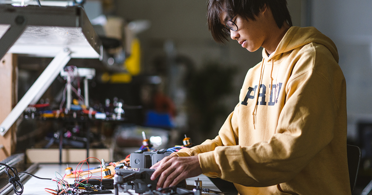 An engineering student works at a station