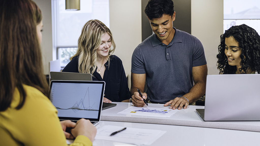 A group of four students discuss data points