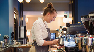 Student working behind a counter.