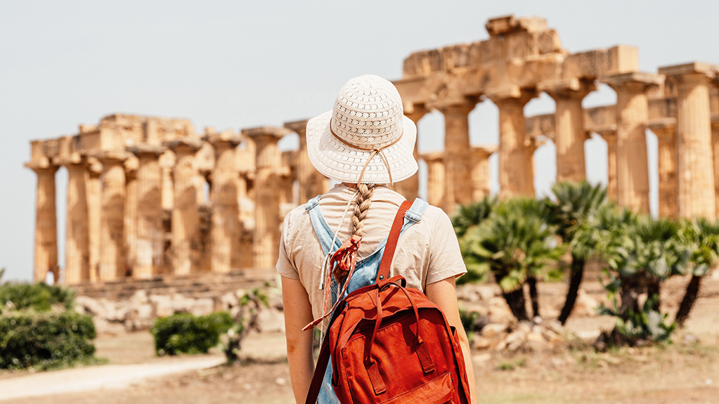 A student looks on at a Greek temple