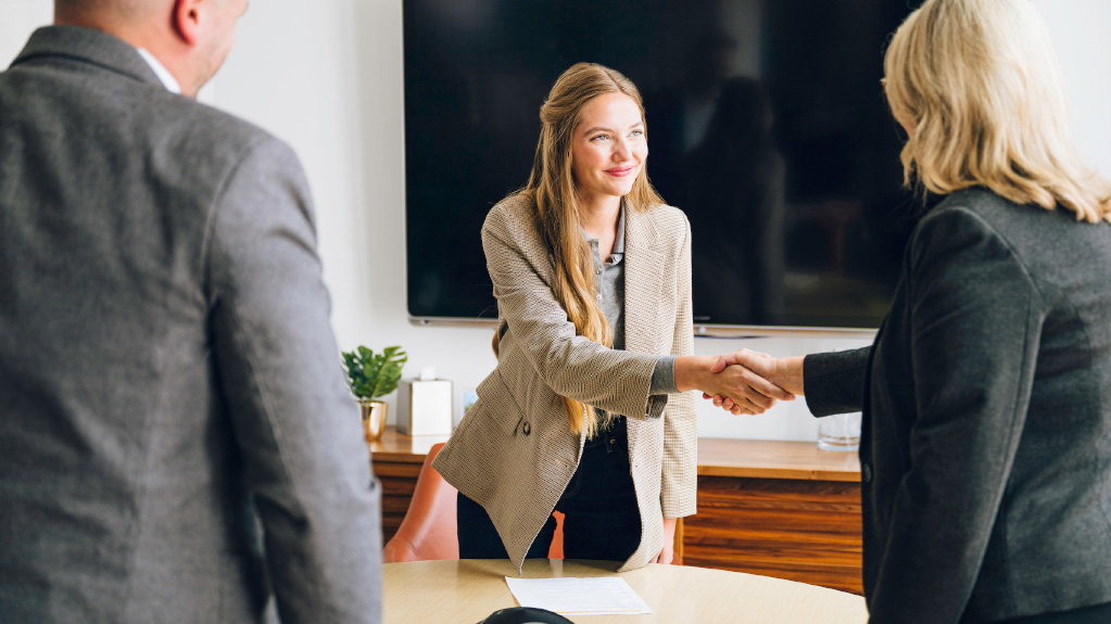 Student shaking hands with a professional