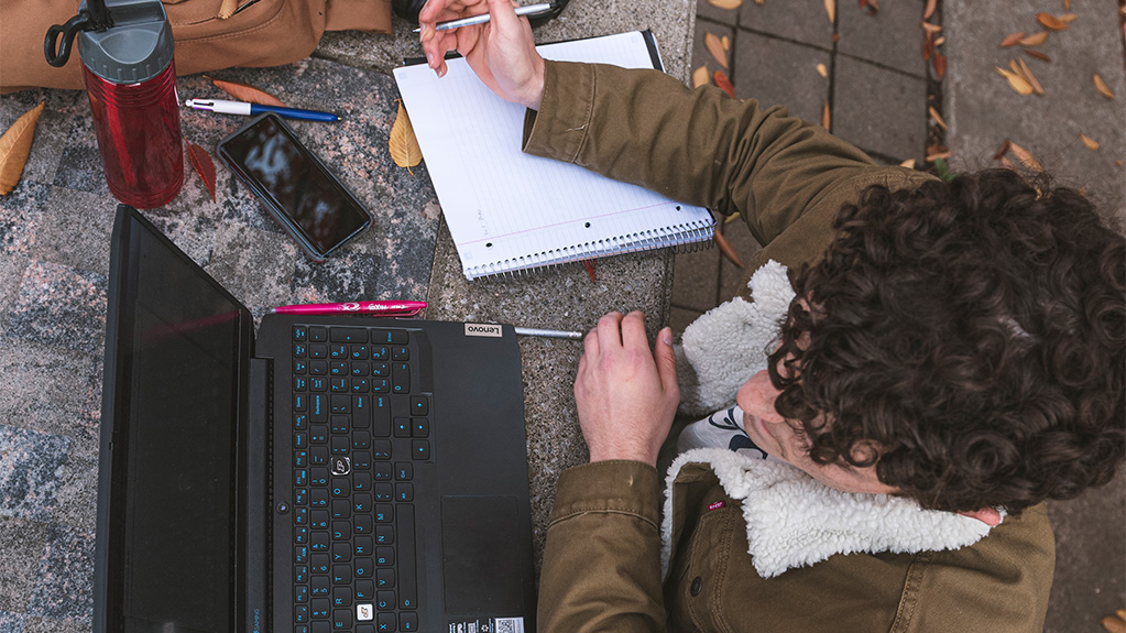 Top down view of student working on laptop