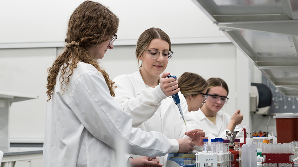 female students in lab with pipette