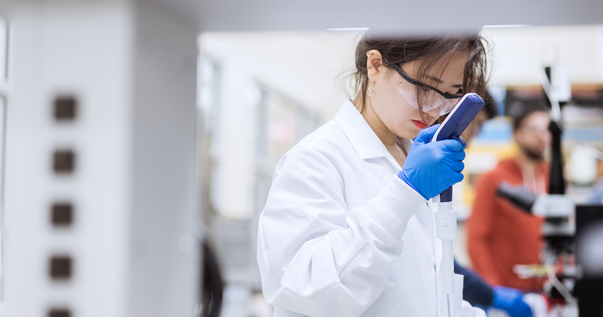 Student in lab using equipment