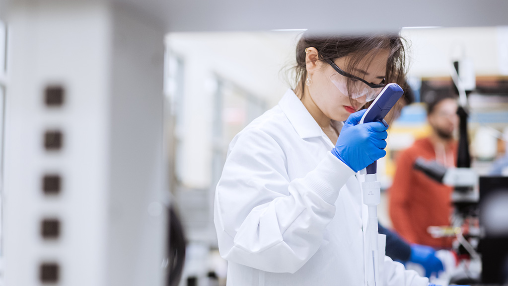 Student in lab using equipment