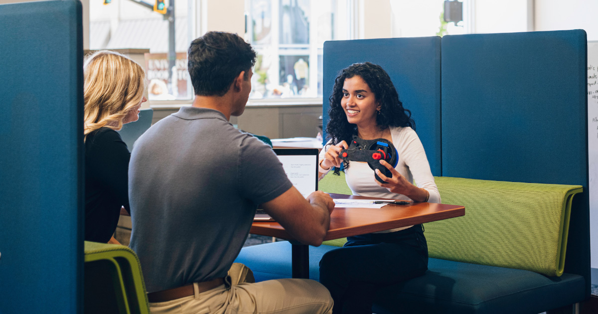 IBE students around a table in discussion