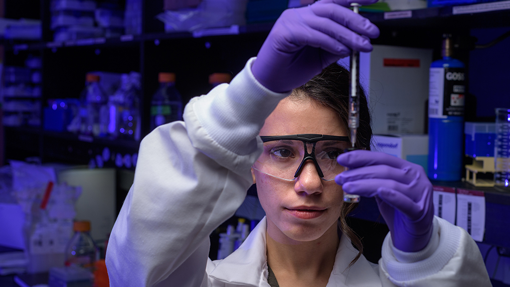 A student fills a vial in a biomedical engineering lab