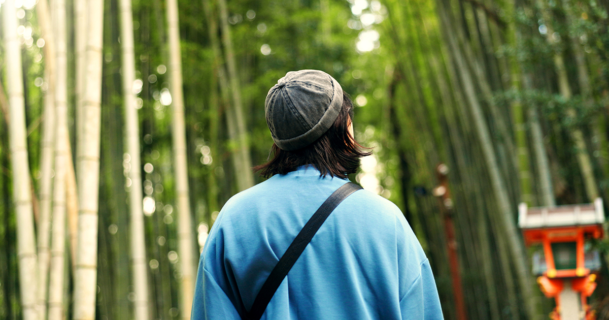 A student walks into bamboo forest in Ariyishiyama, Kyoto, Japan