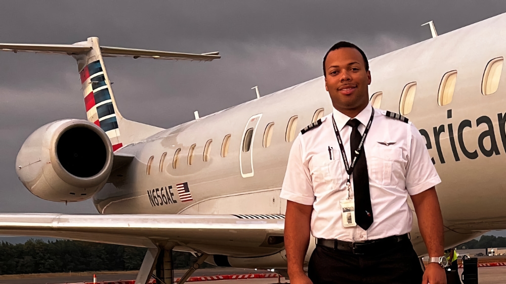 Markell in front of commercial airplane
