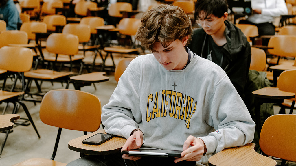 student at desk working on iPad