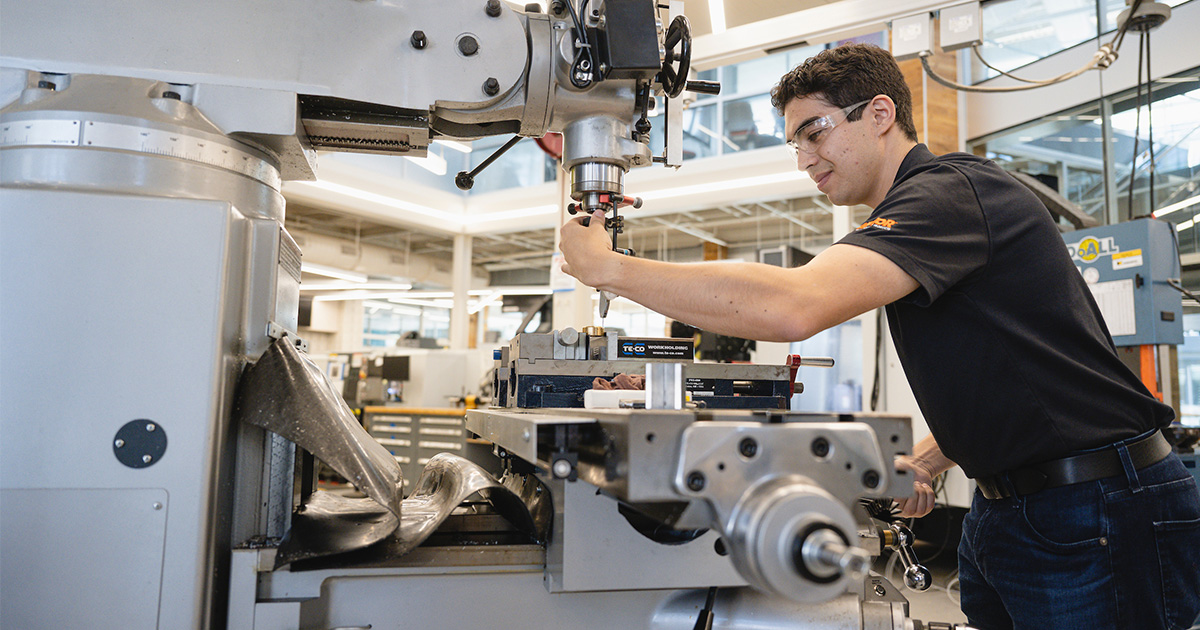 Student using machine in innovation lab