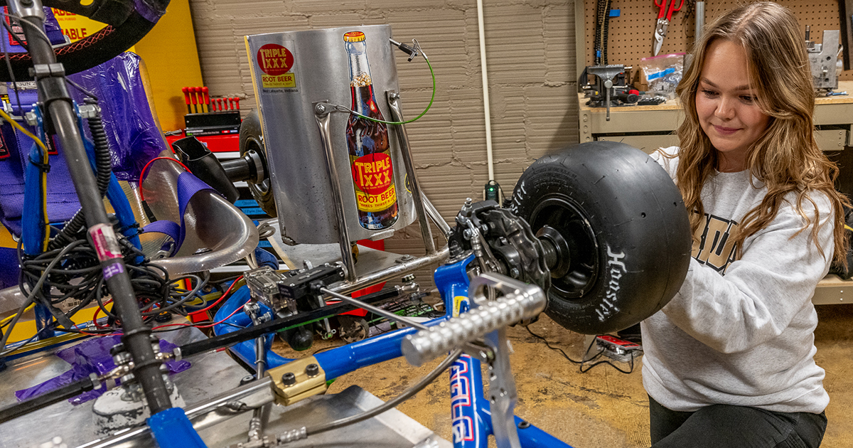 Mollie Parker works on a car during an internship with Dallara