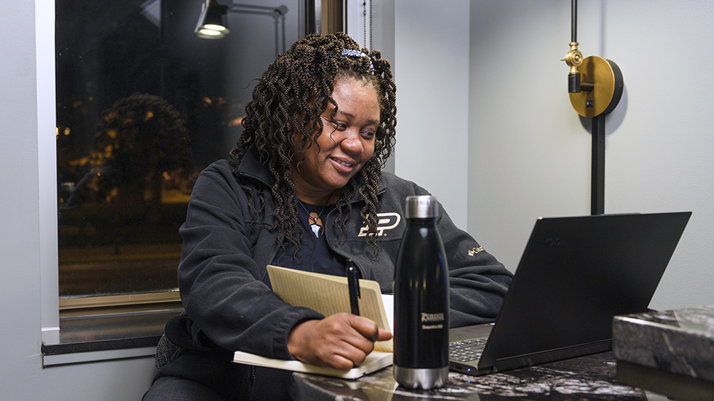 A student works on her laptop taking notes