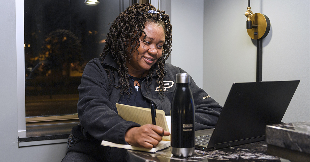 A student works on her laptop taking notes