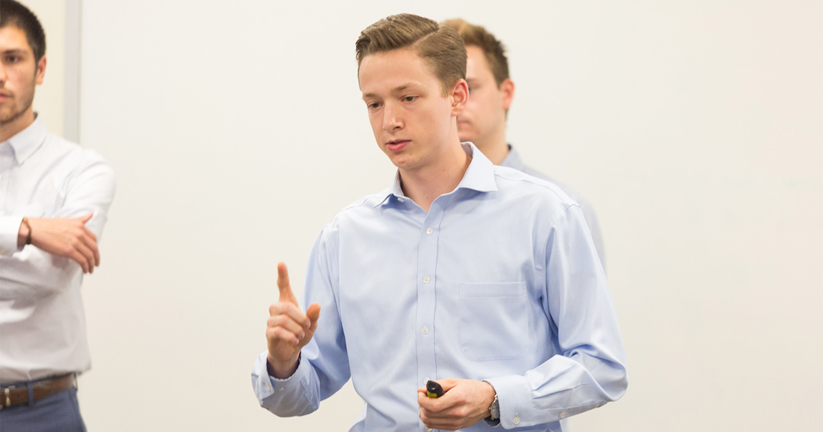 student talking to a crowd in a group