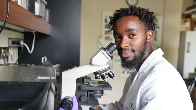 Student using a microscope in a lab