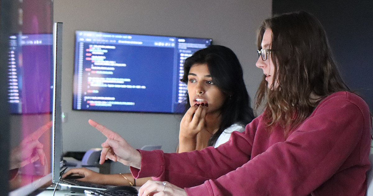 students work together looking at computer monitors