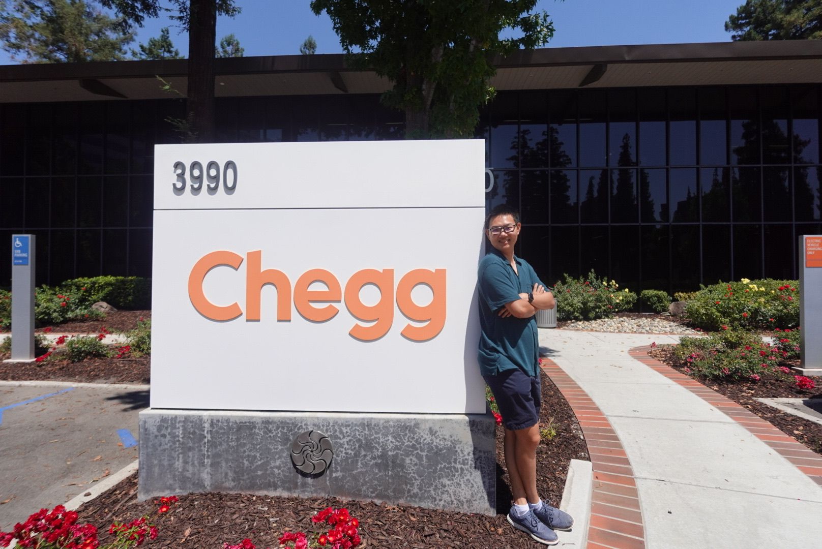 Kevin Huang posing with Chegg sign