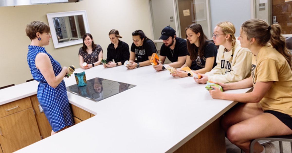Nutrition and dietetics students participate in a classroom activity analyzing food packaging labels.