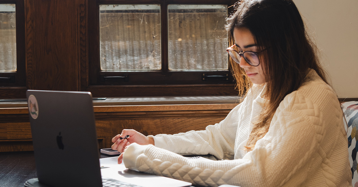 girl at table working on the computer