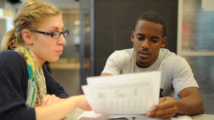 Students looking over documents.