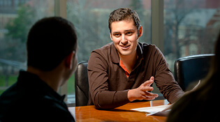 Student talking with counselor.