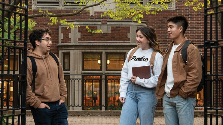 Students talking outside on campus.