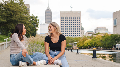 Students sitting and talking outside in downtown Indianapolis.