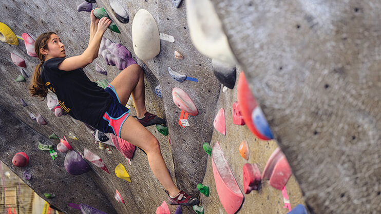 Student indoor rock climbing.