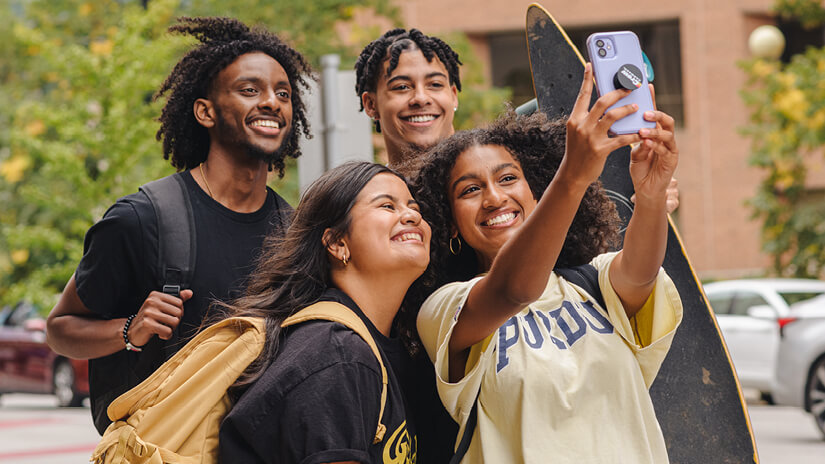 Students taking a group selfie on campus.