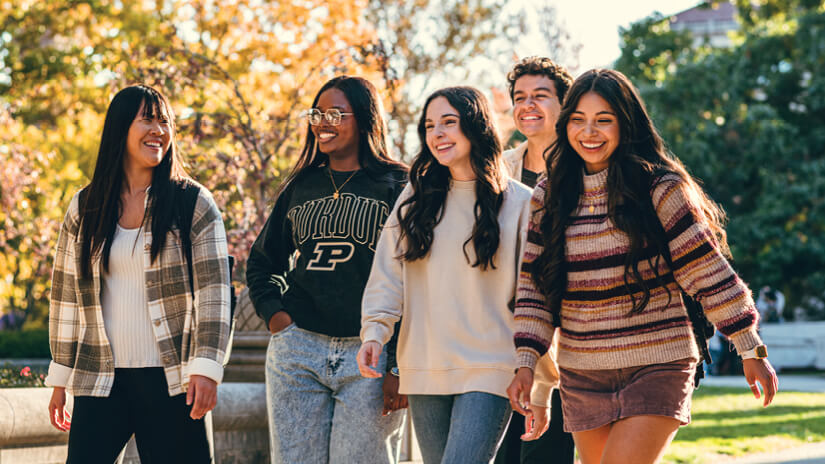 Students walking and laughing on campus.