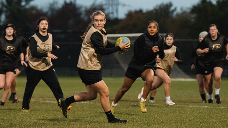 Students playing rugby.