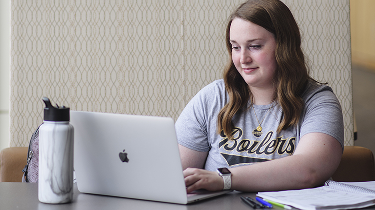 A student works on her laptop