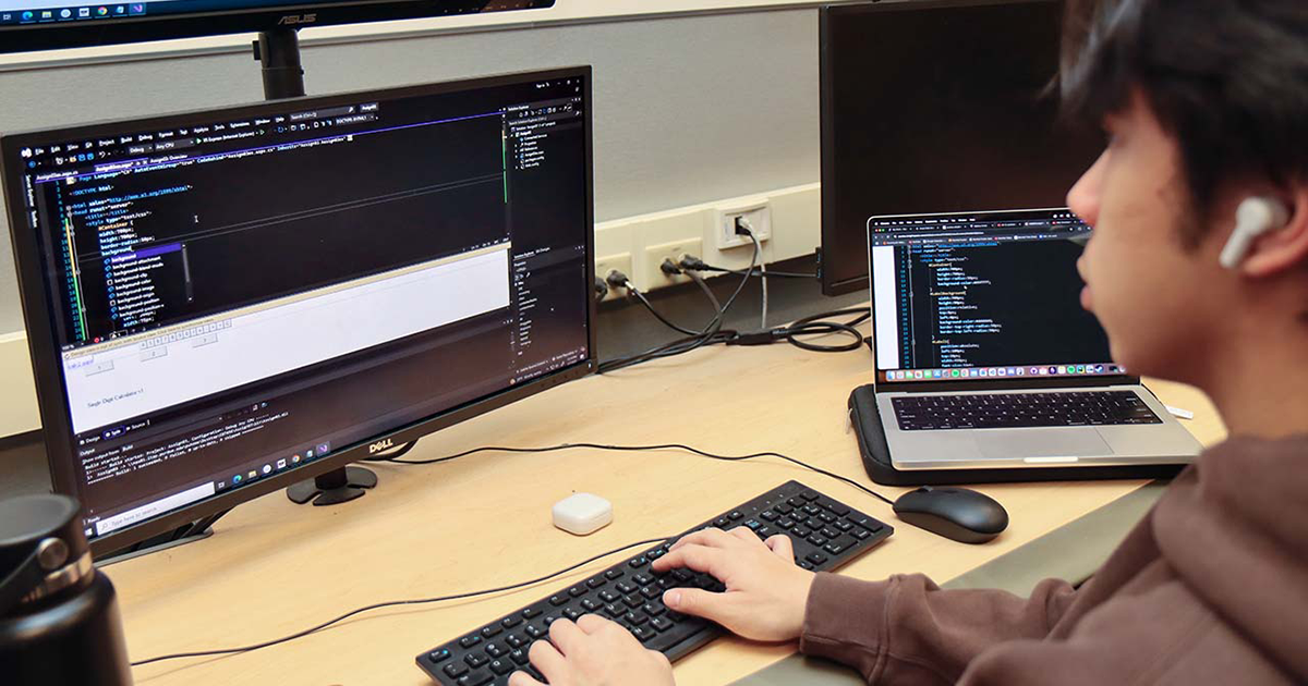 A student works on code on a computer